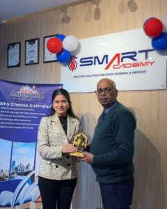 Man and woman receiving award at Smart Academy.